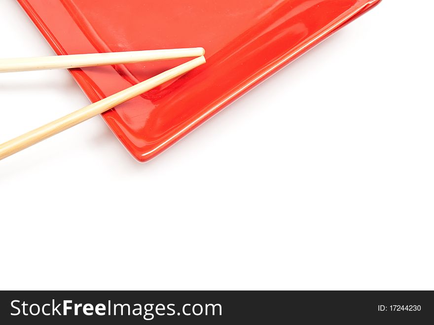 Black and red sushi set (chopsticks and plate) isolated on white background