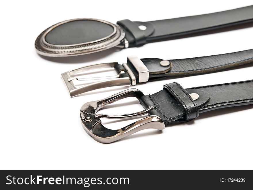 Three leather belts isolated on white background