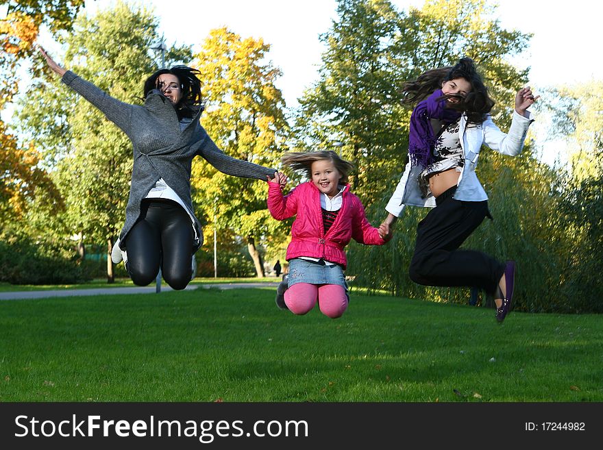 Young family taking healthy stroll through autumn park and have fun. Young family taking healthy stroll through autumn park and have fun