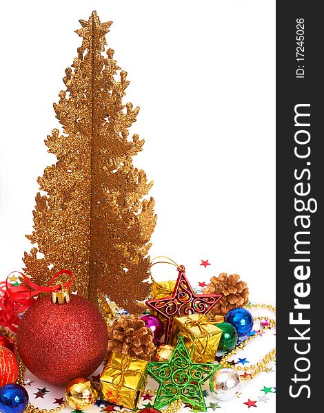 Colorful Christmas baubles and decorations next to golden tree isolated on white background with copy space. Colorful Christmas baubles and decorations next to golden tree isolated on white background with copy space.