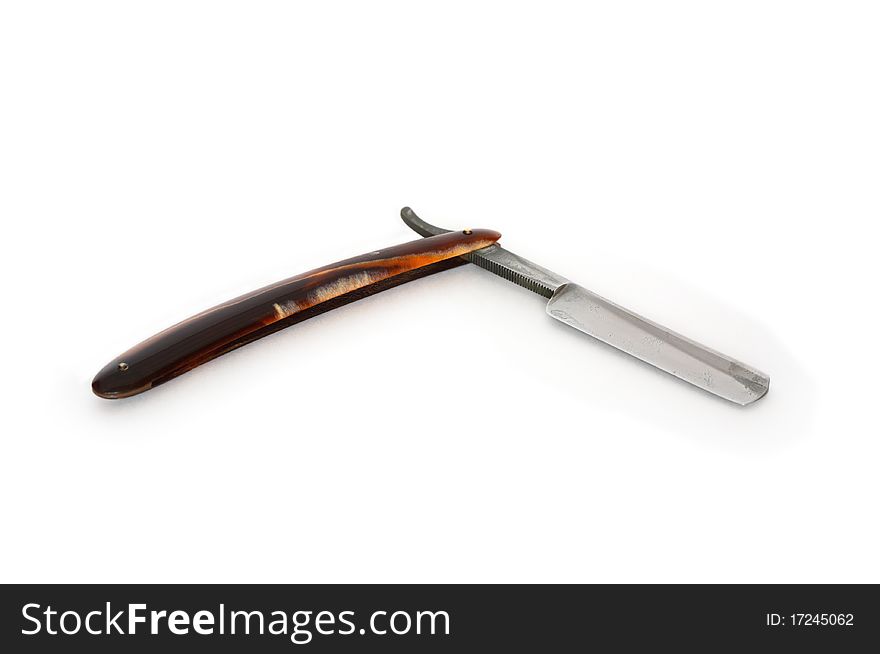 Very old rusty classic straight razor lying on white background. Very old rusty classic straight razor lying on white background