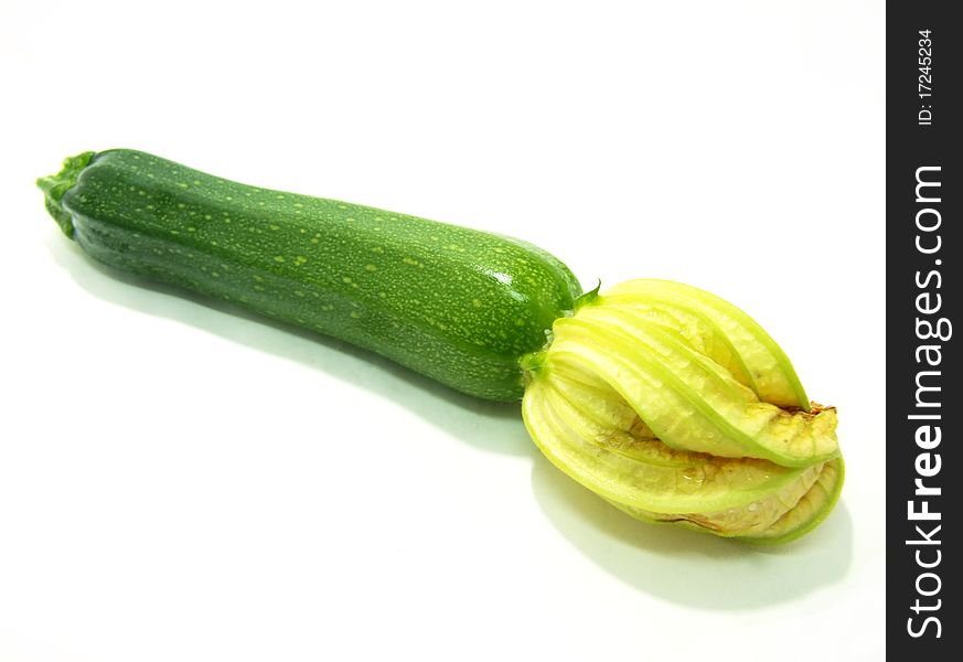 A green courgette on a white background. A green courgette on a white background.