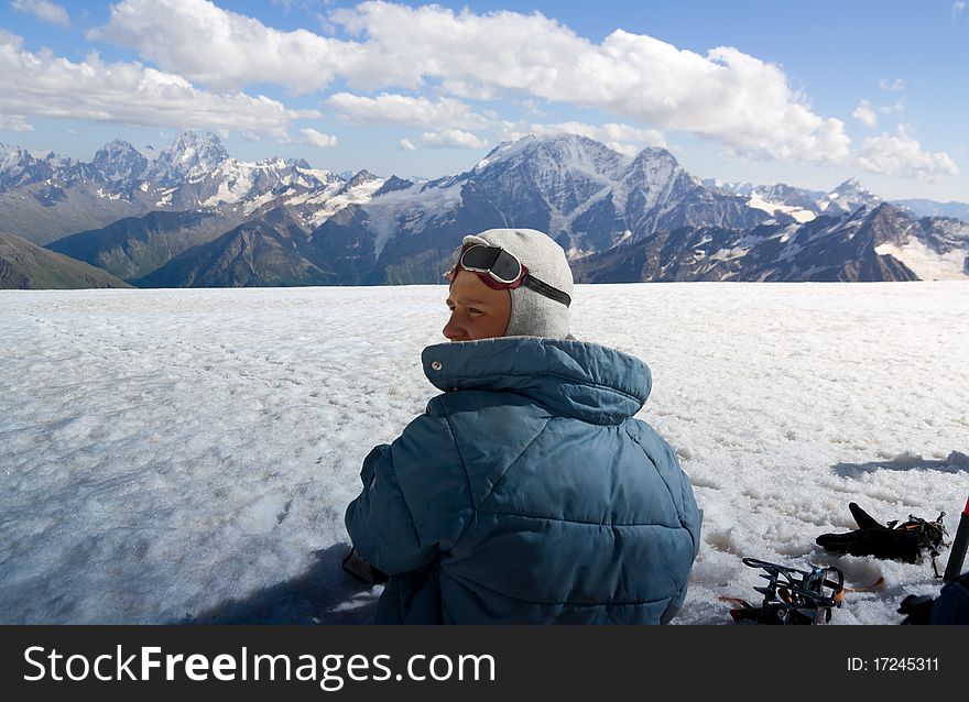 A teenager rests. Ascent on a mountain. A teenager rests. Ascent on a mountain.