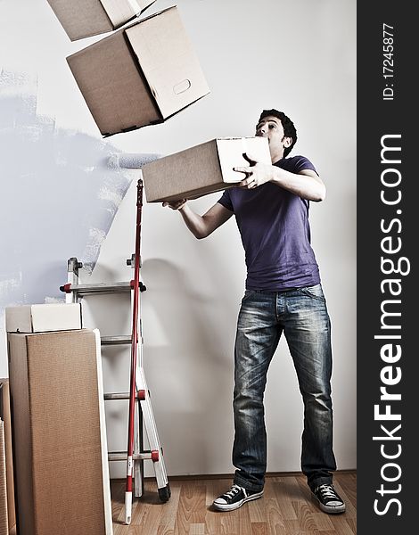 Man Carrying Stacked Boxes on moving day, desaturated image