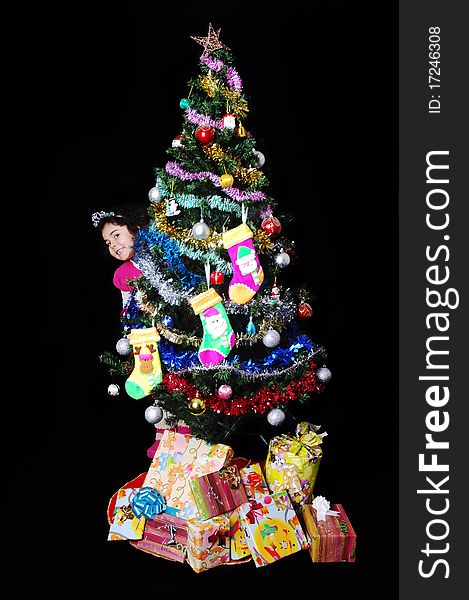 A girl and a christmas tree with presents. A girl and a christmas tree with presents