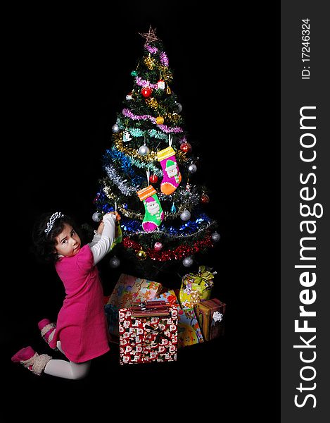 A girl and a christmas tree with presents. A girl and a christmas tree with presents