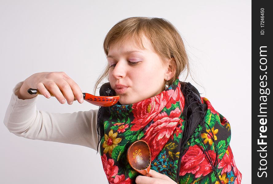 Russian girl in a headscarf with a spoon