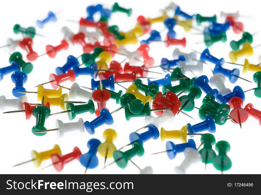 Colored Push Pins on white background.