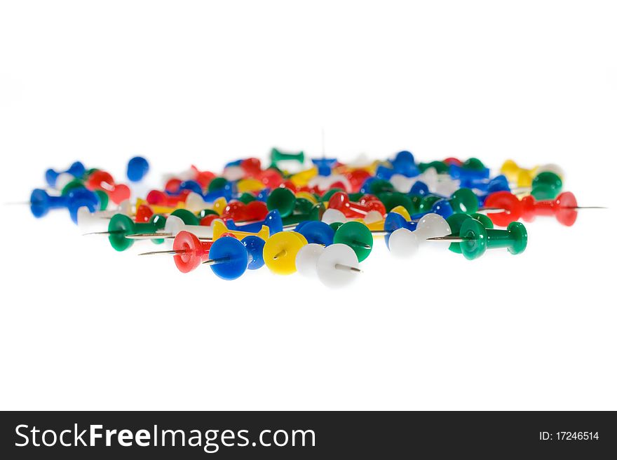 Colored Push Pins on white background.
