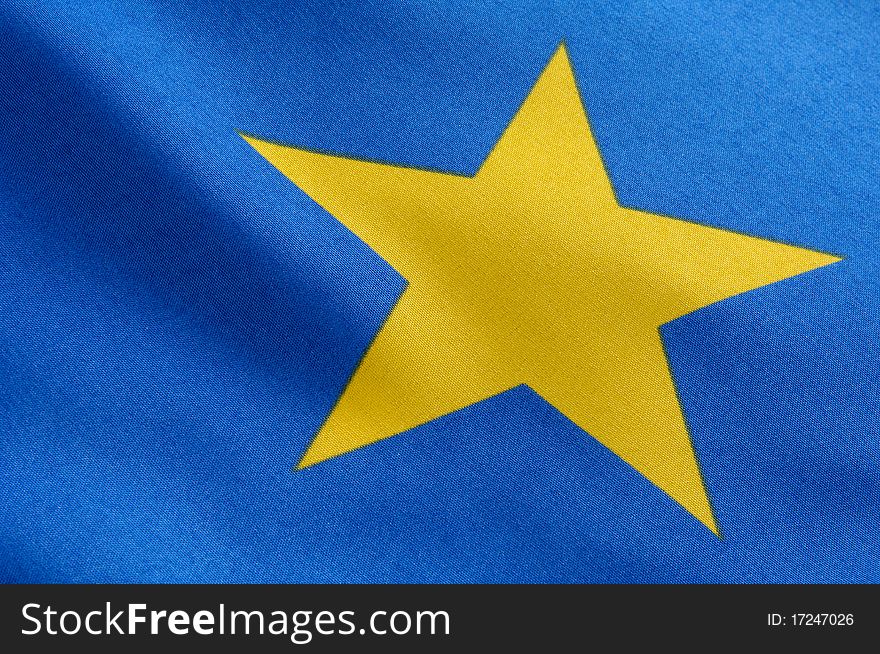 Part of a european flag, one yellow star on blue ground