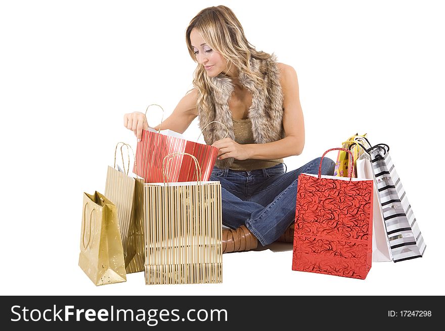 blond woman with shopping bags smiling happily. blond woman with shopping bags smiling happily