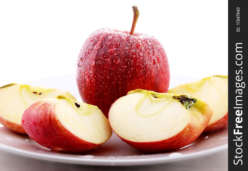 Red apples on white plate towards white background