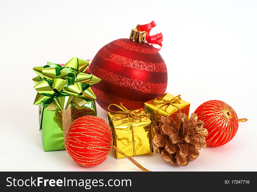 Red Christmas baubles and other decorations on light background with copy space.