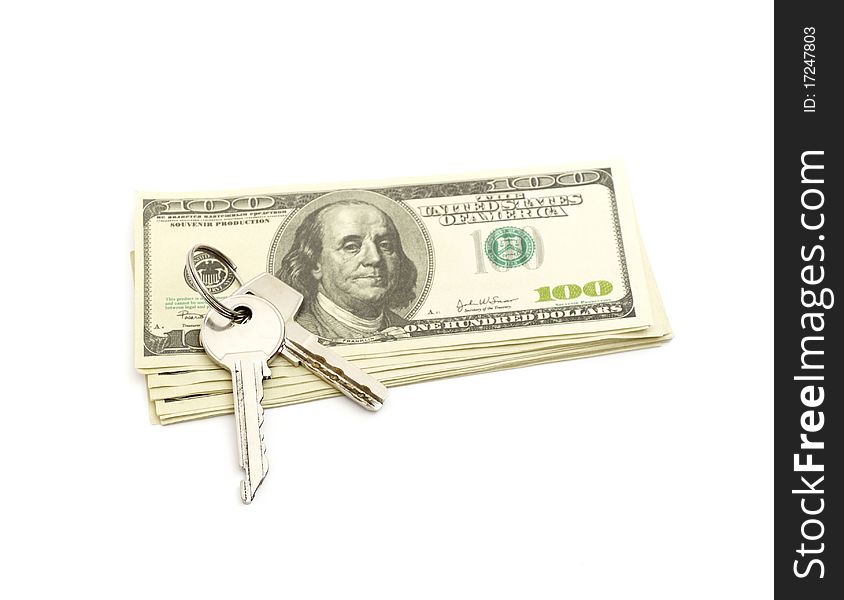 Keys and stack of dollars isolated on a white background