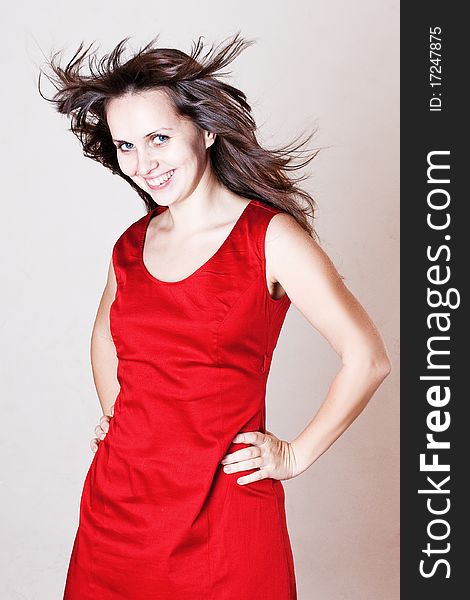 Beauty woman with hairs on the wind in red dress