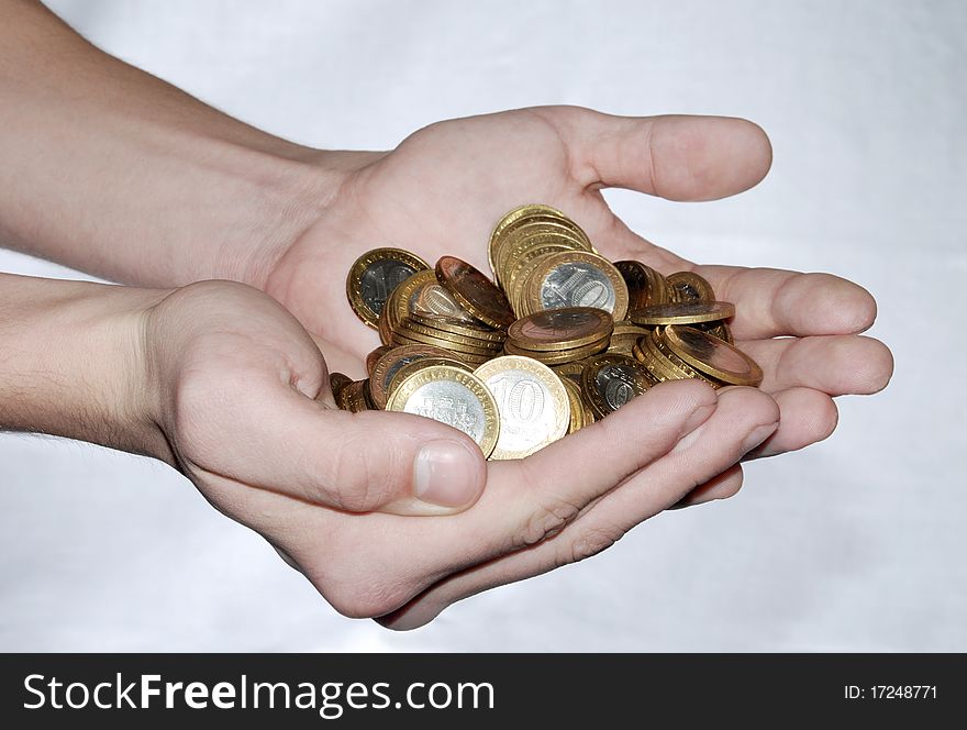 Full handful of coins on a white background