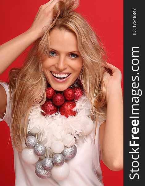 female christmas angel smiling with some feathers and balls around the neck. female christmas angel smiling with some feathers and balls around the neck
