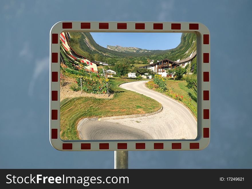 Photo of a tree in bloom on a mirror of road signs in Switzerland. Photo of a tree in bloom on a mirror of road signs in Switzerland