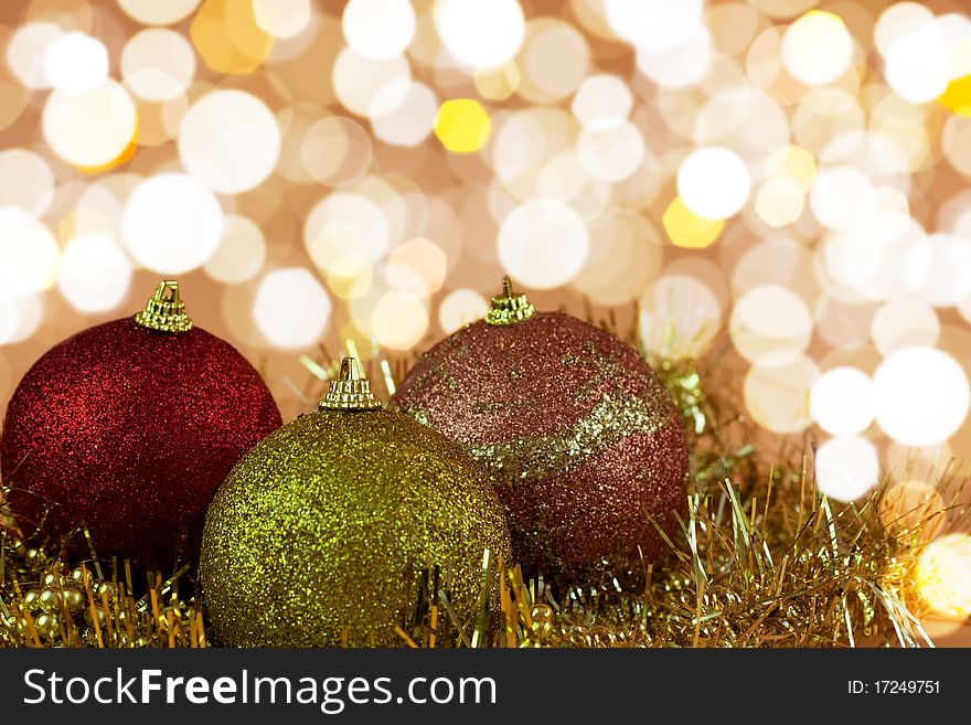 Red,yellow and gold Christmas baubles on background of defocused golden lights.Shallow DOF. Red,yellow and gold Christmas baubles on background of defocused golden lights.Shallow DOF