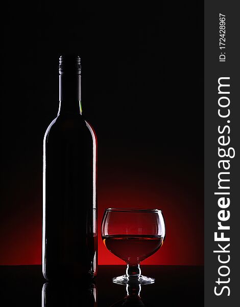 Wine Bottle and Glass on Dark Background