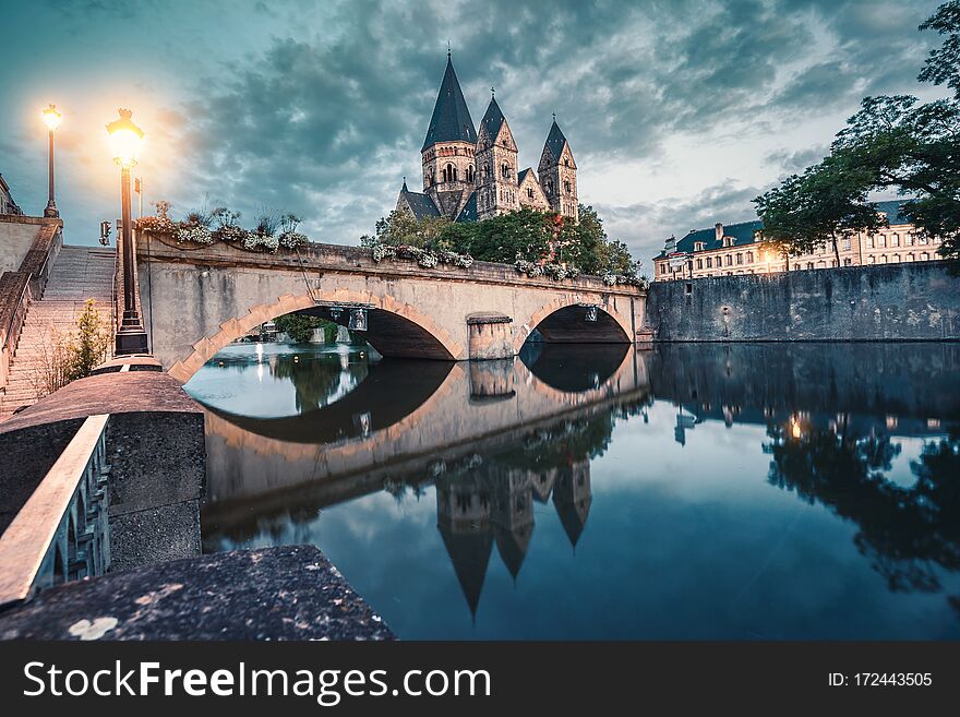 City View Of An Ancient Neuf Church On The Bank Of The Moselle River In Metz In France During The Sunrise. Tourist