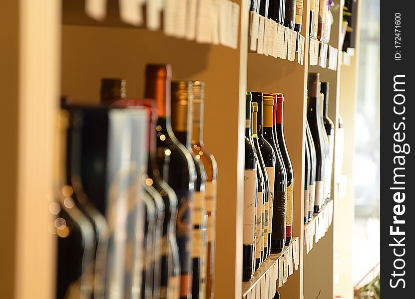 Wine bottles on wooden shelf