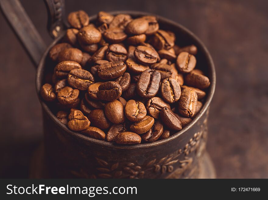 Coffee beans on the rustic wooden background. Selective focus. Shallow depth of field.