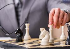 Young Businessman Playing Chess In The Office Royalty Free Stock Photography