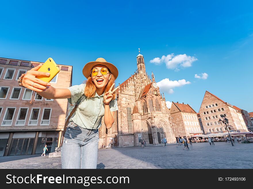 Asian Girl Tourist And Traveller Enjoying A Warm Summer Day On The Main Square Of Nuremberg During Sunset. Sights Of Germany