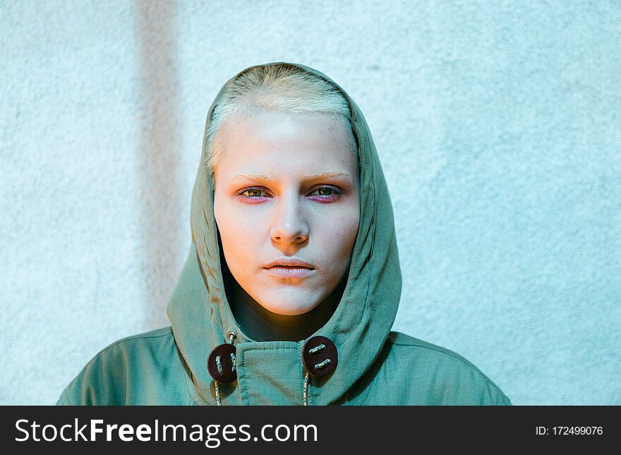 Young Androgyne Woman with short blond hair on the street, natural light