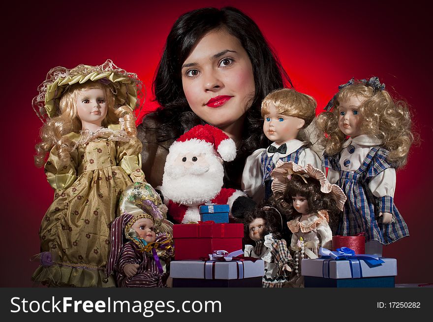 Young female with her dolls and santa claus receiving christmas gifts. Young female with her dolls and santa claus receiving christmas gifts