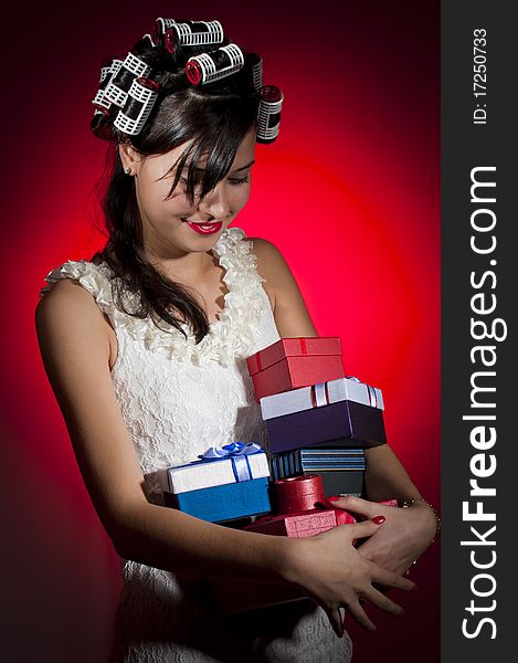 Young happy female holding gifts in christmas eve. Young happy female holding gifts in christmas eve