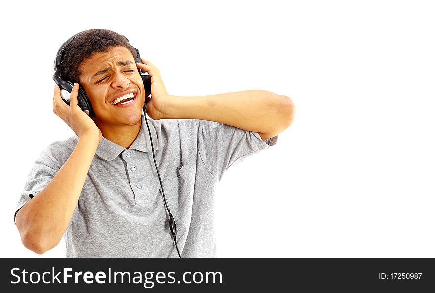 Young happy man listening to music and singing