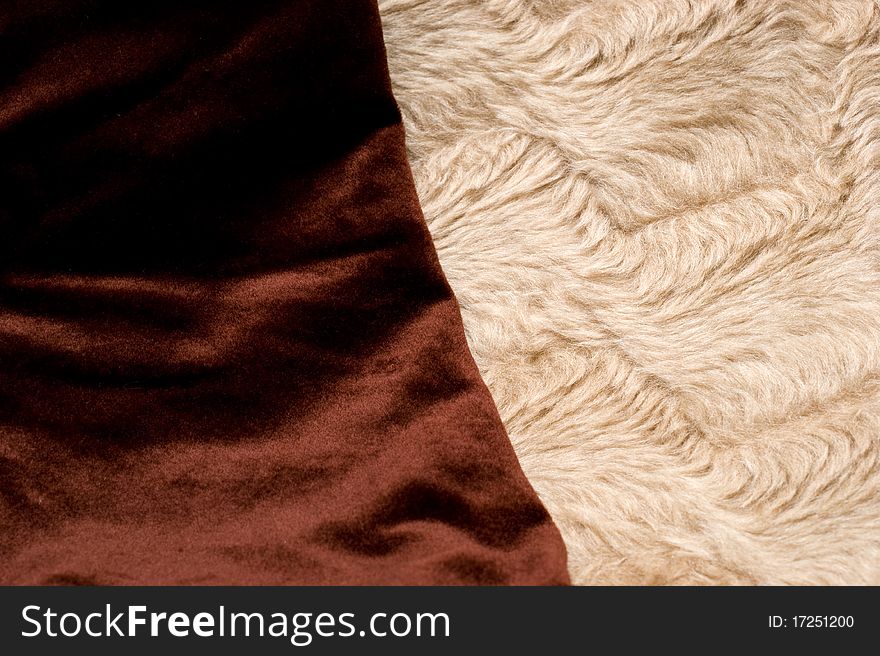 The background of textured brown and light synthetic fabric closeup