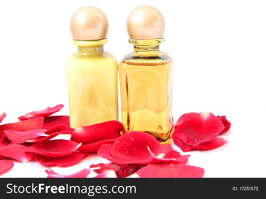 Spa treatment beautiful spa background. Natural Cosmetics cream and shampoo or massage oil with rose petals isolated on a white background