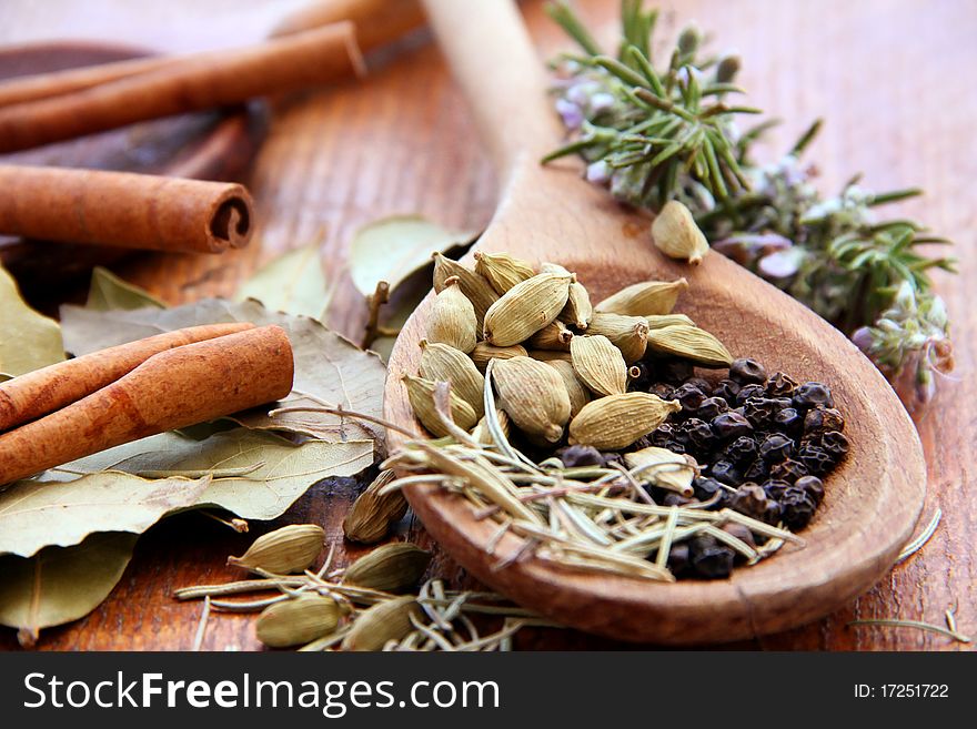 Macro view of the different spices on wooden background