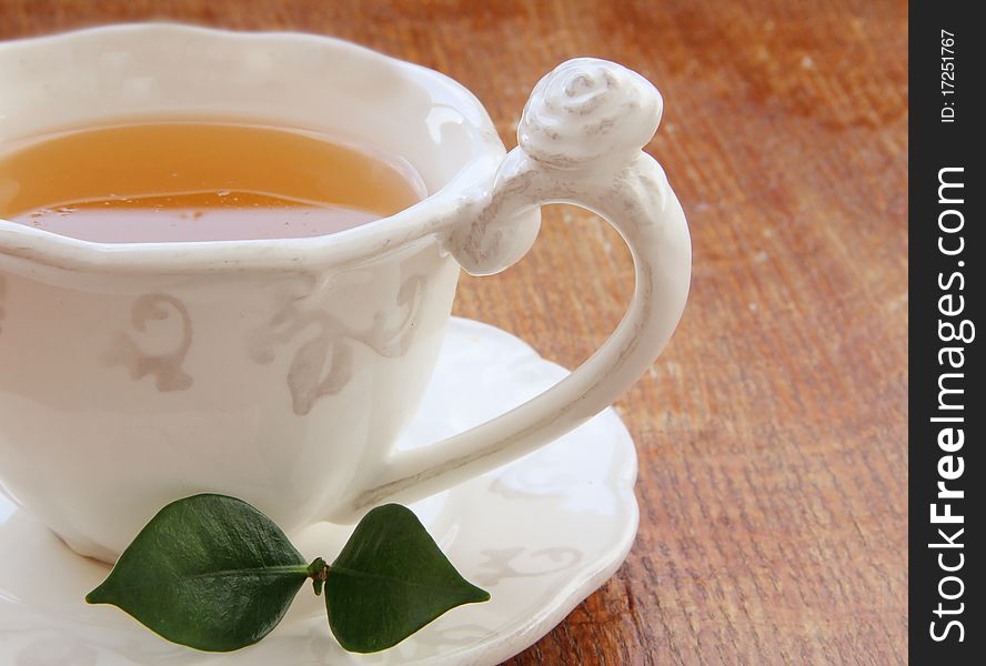 Pouring Tea.cup of tea .Herbal tea on a wooden table