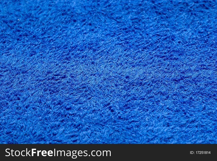 The background of textured blue cotton fabric closeup