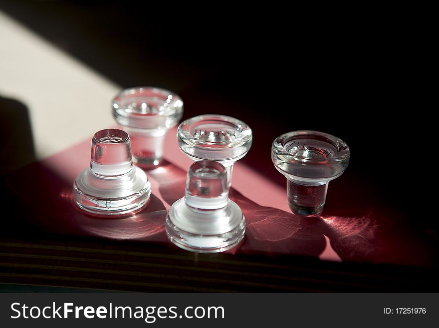 Closure for vine bottles laying on the table with light reflections.