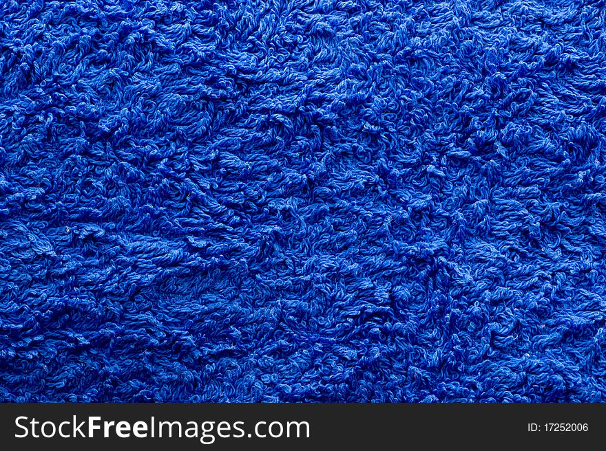 The background of textured blue cotton fabric closeup