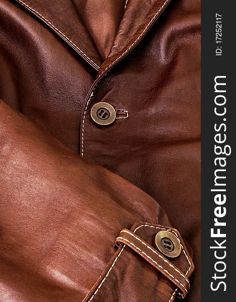Detail of clothing and leather in brown. Detail of clothing and leather in brown