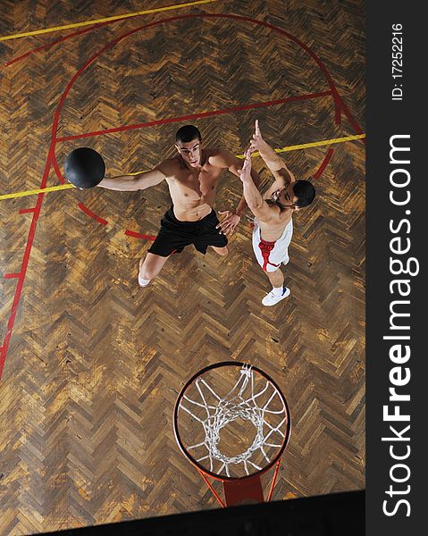 Young and healthy people man have recreation and training exercise while play basketball game at sport gym indoor hall. Young and healthy people man have recreation and training exercise while play basketball game at sport gym indoor hall