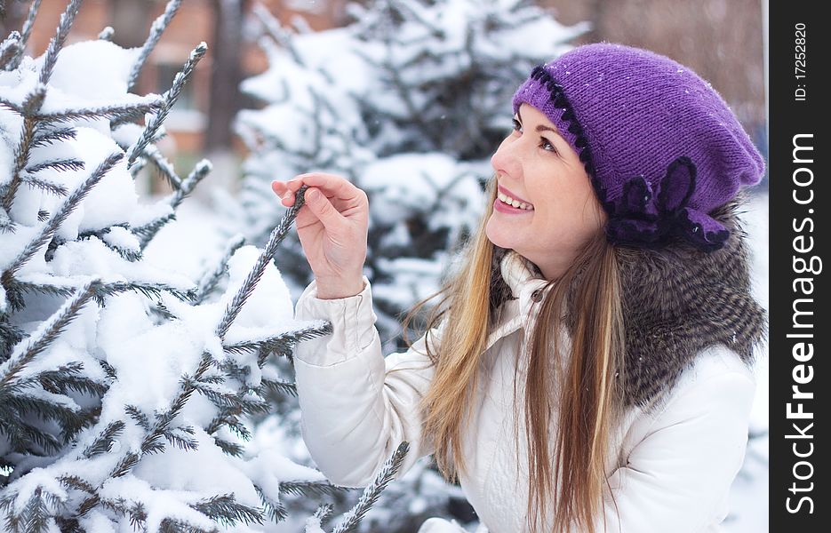 A young girl touched his hand a branch eating, winter, snow