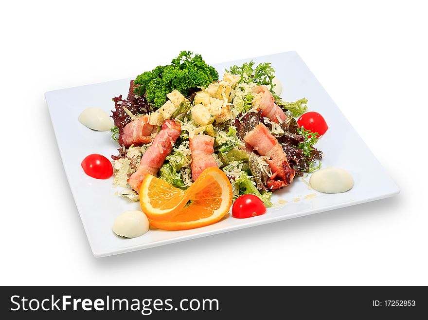 Meat dish steak with vegetables and herbs on a ceramic platter. Meat dish steak with vegetables and herbs on a ceramic platter