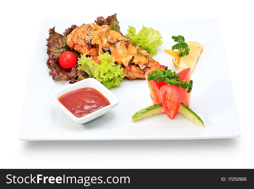 Meat dish steak with vegetables and herbs on a ceramic platter. Meat dish steak with vegetables and herbs on a ceramic platter