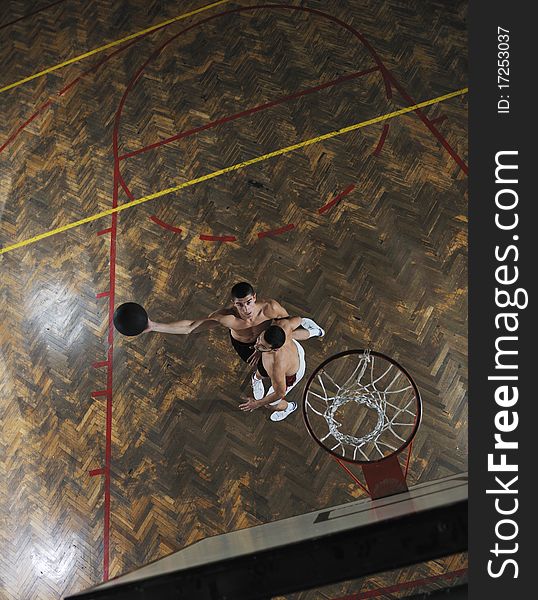 Young and healthy people man have recreation and training exercise  while play basketball game at sport gym indoor hall. Young and healthy people man have recreation and training exercise  while play basketball game at sport gym indoor hall