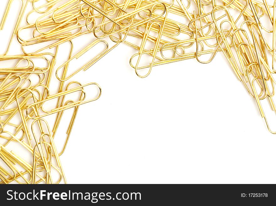 Gleaming golden paperclip isolated on white background