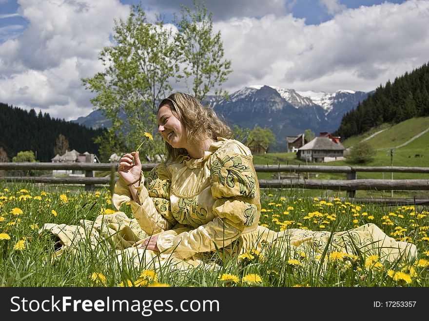 Medieval lady smelling a flower. The photo is taken in a village called Fundata near Brasov, Romania. Photo taken on: May 23rd, 2010