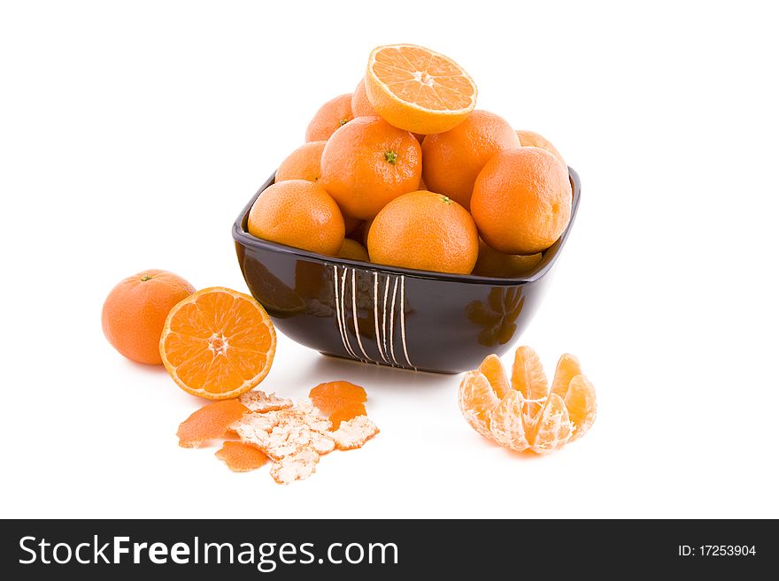 Fresh juicy tangerines in black bowl isolated on white background. Fresh juicy tangerines in black bowl isolated on white background