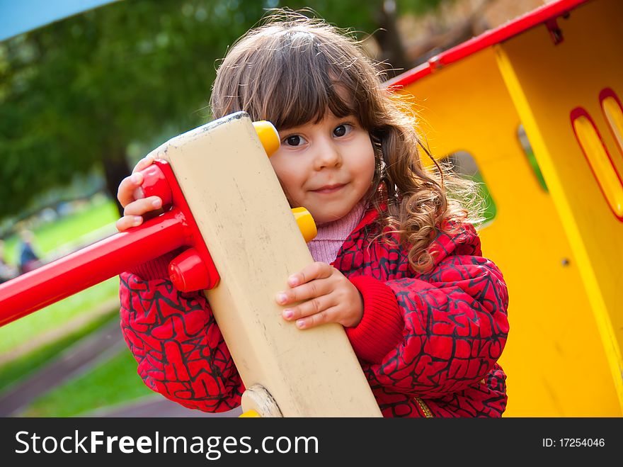 Little girl portrait in playground in a park